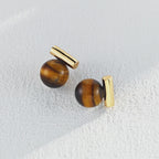 The Tiger's Eye and Black Onyx Stud Earrings elegantly displayed inside an open gift box.
