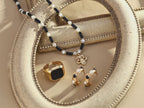 Elegantly packaged vintage pearl and onyx stud earrings, ready as a sophisticated gift option