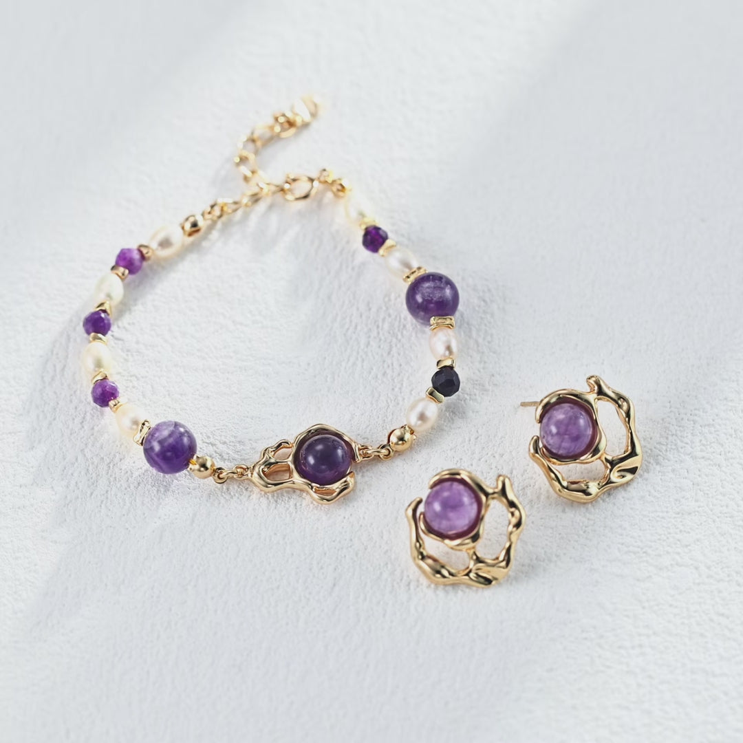 Liquid metal and amethyst earrings catching the light, showcasing the metallic luster and gemstone brilliance.