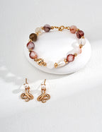 Close-up of the 8mm red agate crystal bead showing its warm, captivating luster and natural inclusions.