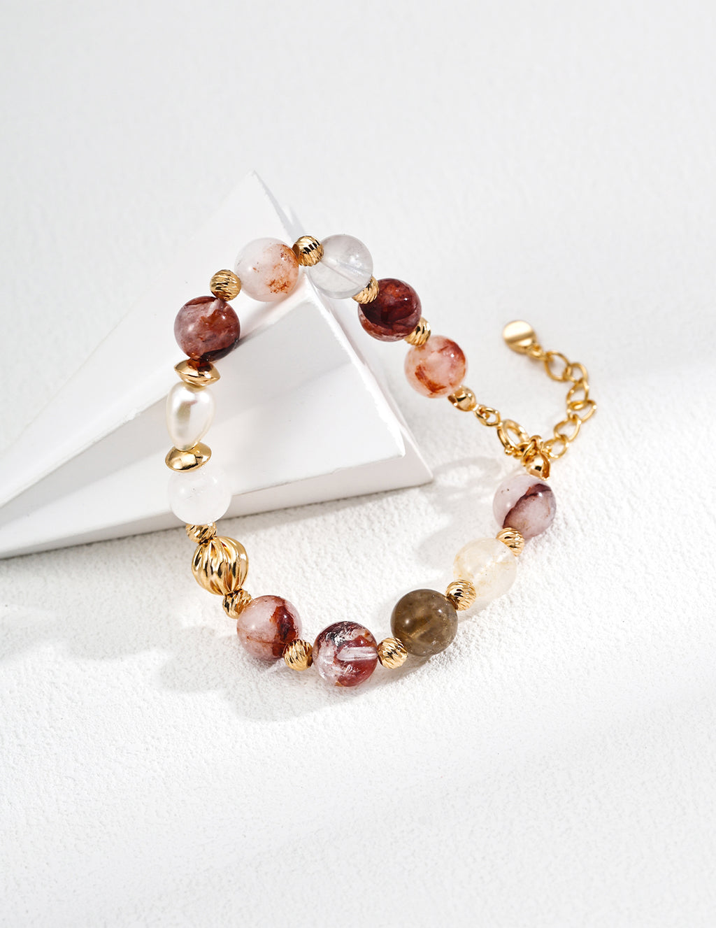 the natural pearl and red agate crystal bracelet on the ground.