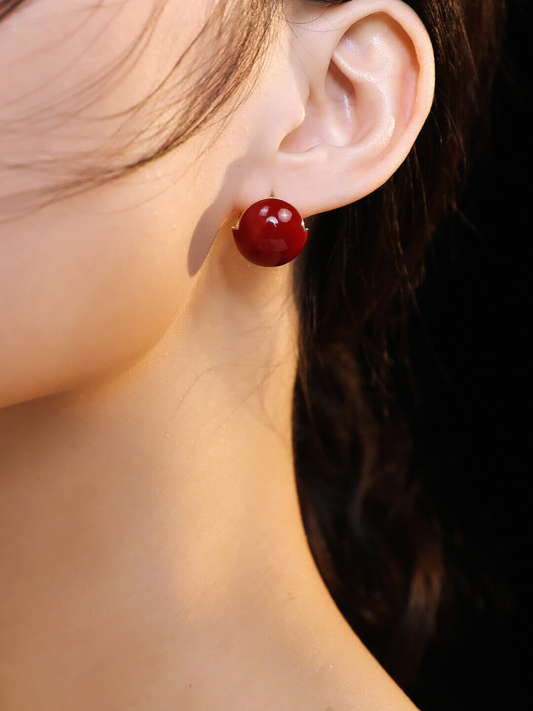Side view of red enamel drop earrings on model, showcasing the 17mm elegant drop and vibrant color.