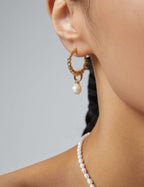 Model showcasing the vintage gold plated natural pearl earrings.