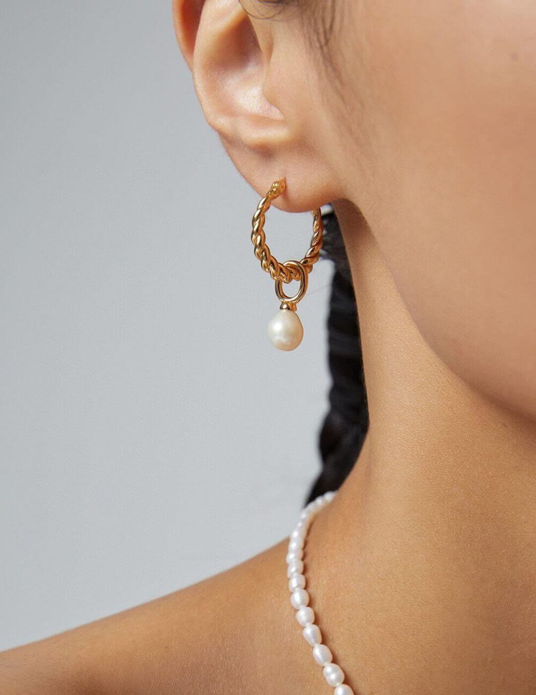 Model showcasing the vintage gold plated natural pearl earrings.
