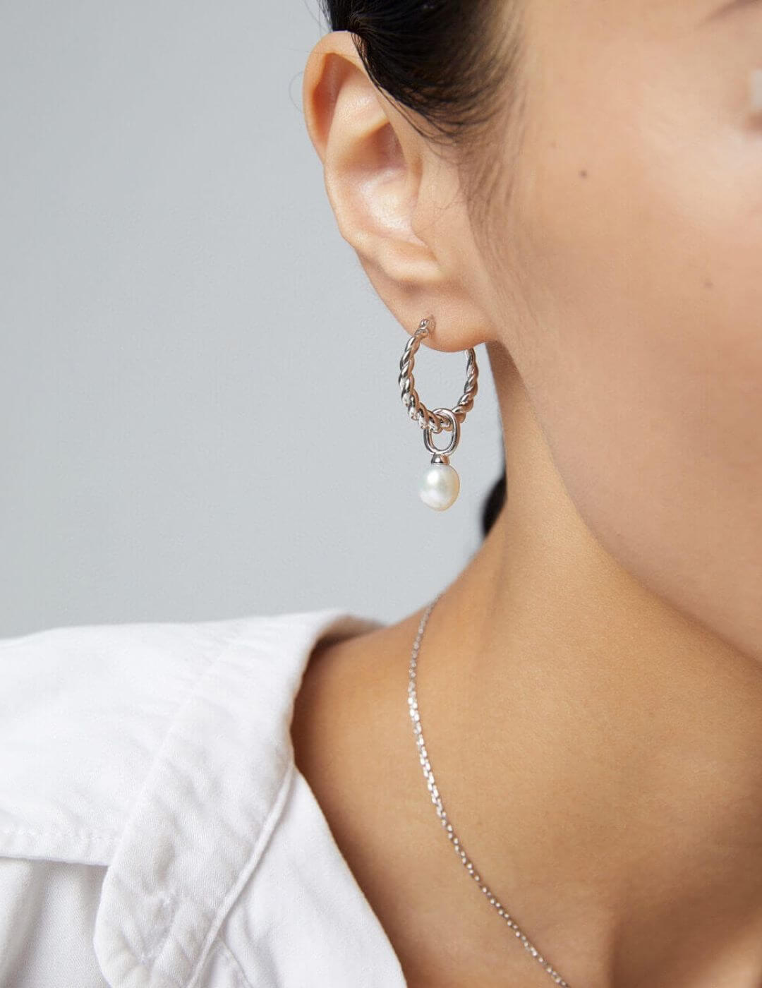 Model wearing the silver plated natural pearl drop earrings.
