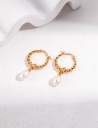 Natural pearl drop earrings in warm vintage gold plating.
