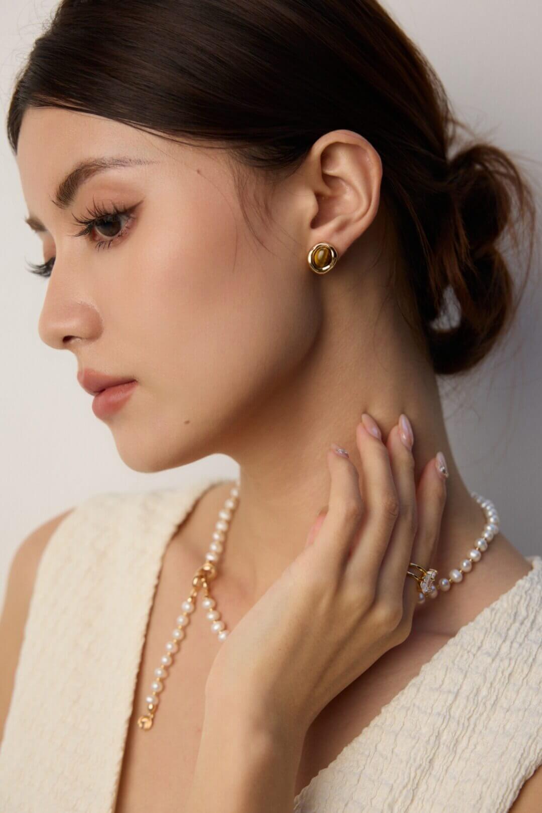 Model wearing the Silver plated Tiger's Eye stud earrings.