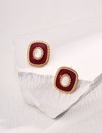 Close-up of the white shell pendant with a soft moonlight glow in these minimalist earrings