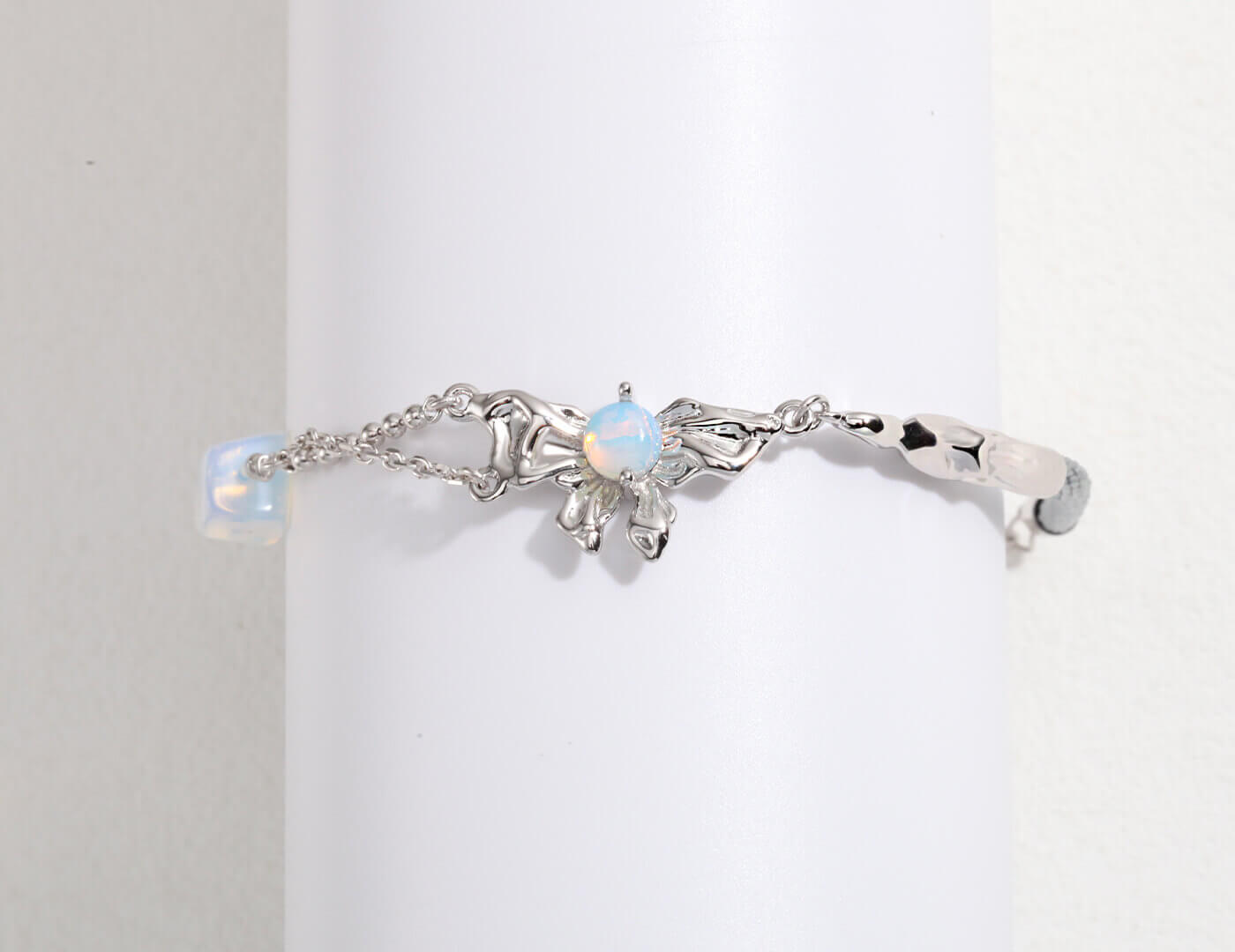 Silver bracelet with opal stones on a light gray background