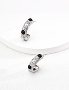 White gold finish natural pearl and black onyx stud earrings, offering fresh vitality and everyday elegance.