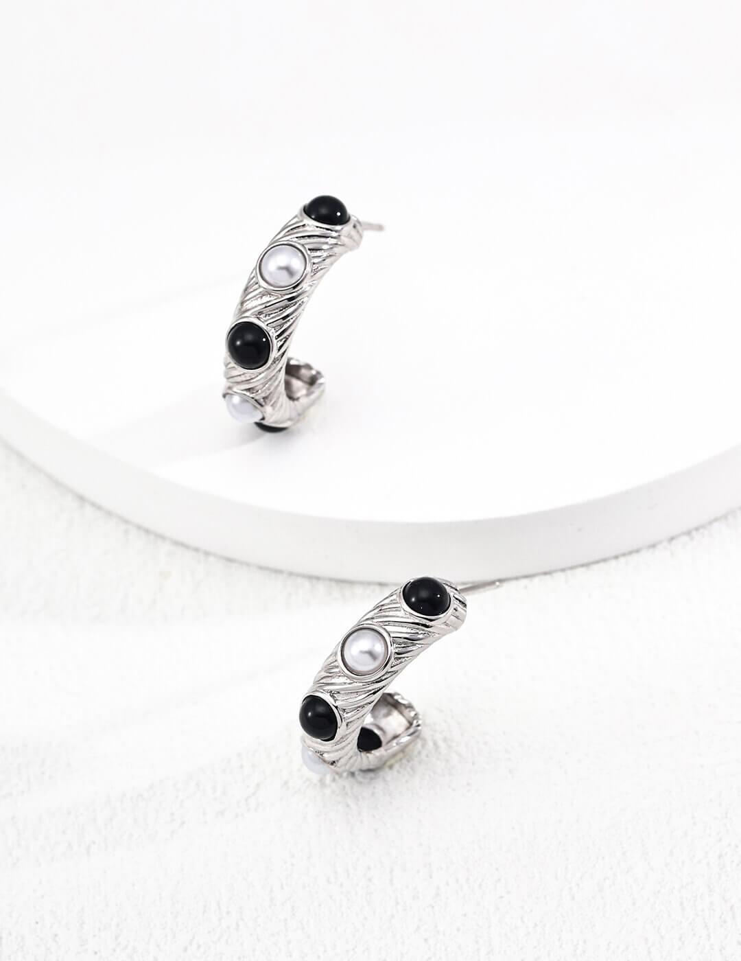 White gold finish natural pearl and black onyx stud earrings, offering fresh vitality and everyday elegance.
