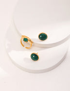 A single minimalist malachite stud earring, embodying simple and understated sophistication.