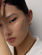 sophisticated pearl and onyx stud earrings providing elegant accent for formal evening occasions.