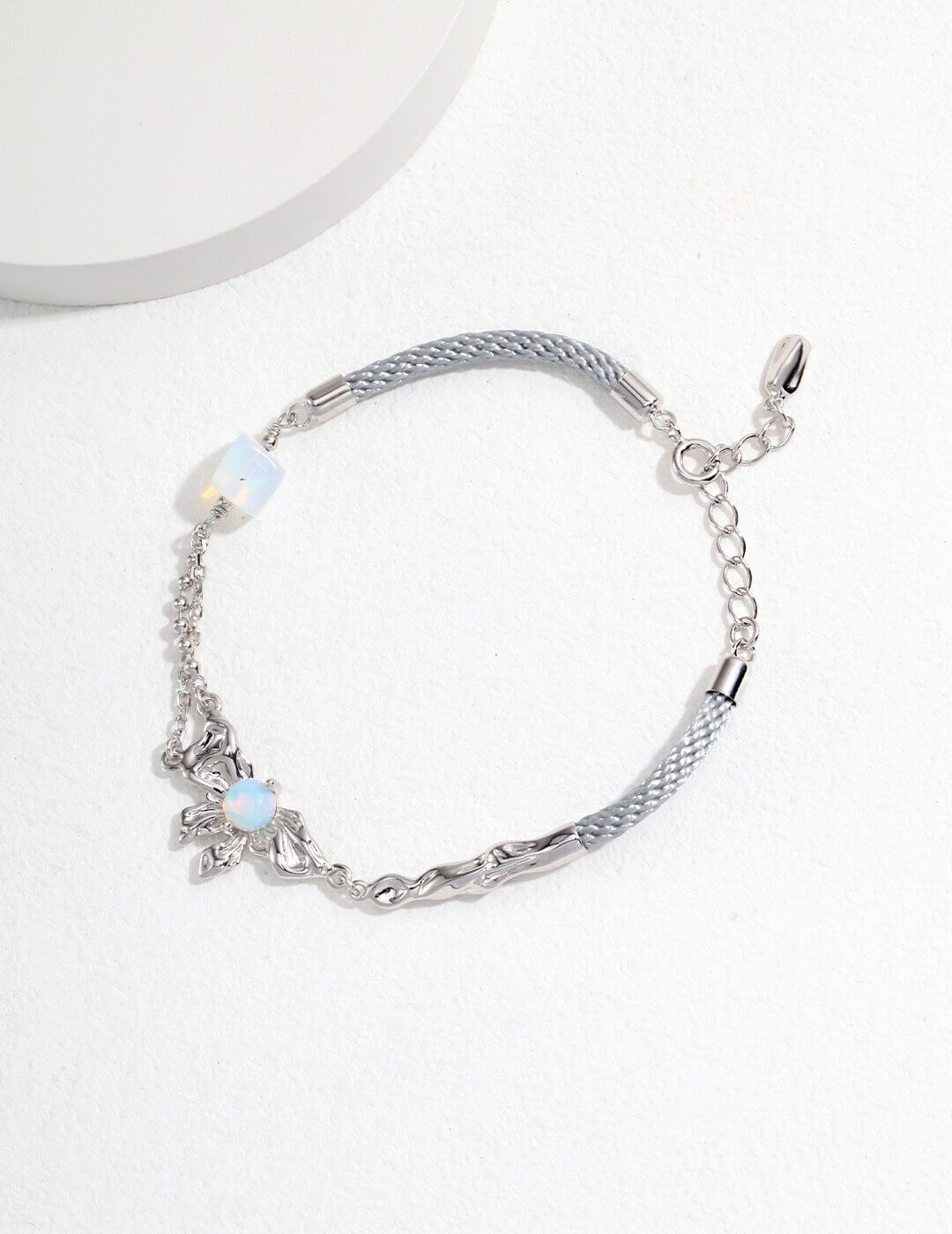 Silver bracelet with starfish charm on a white background