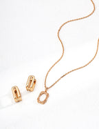 Rose gold necklace and clips on a white background