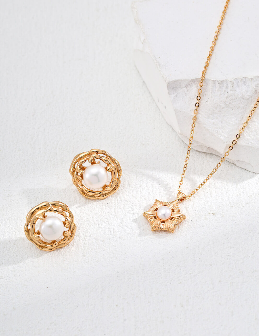 Gold jewelry set with necklace and earrings on a white background