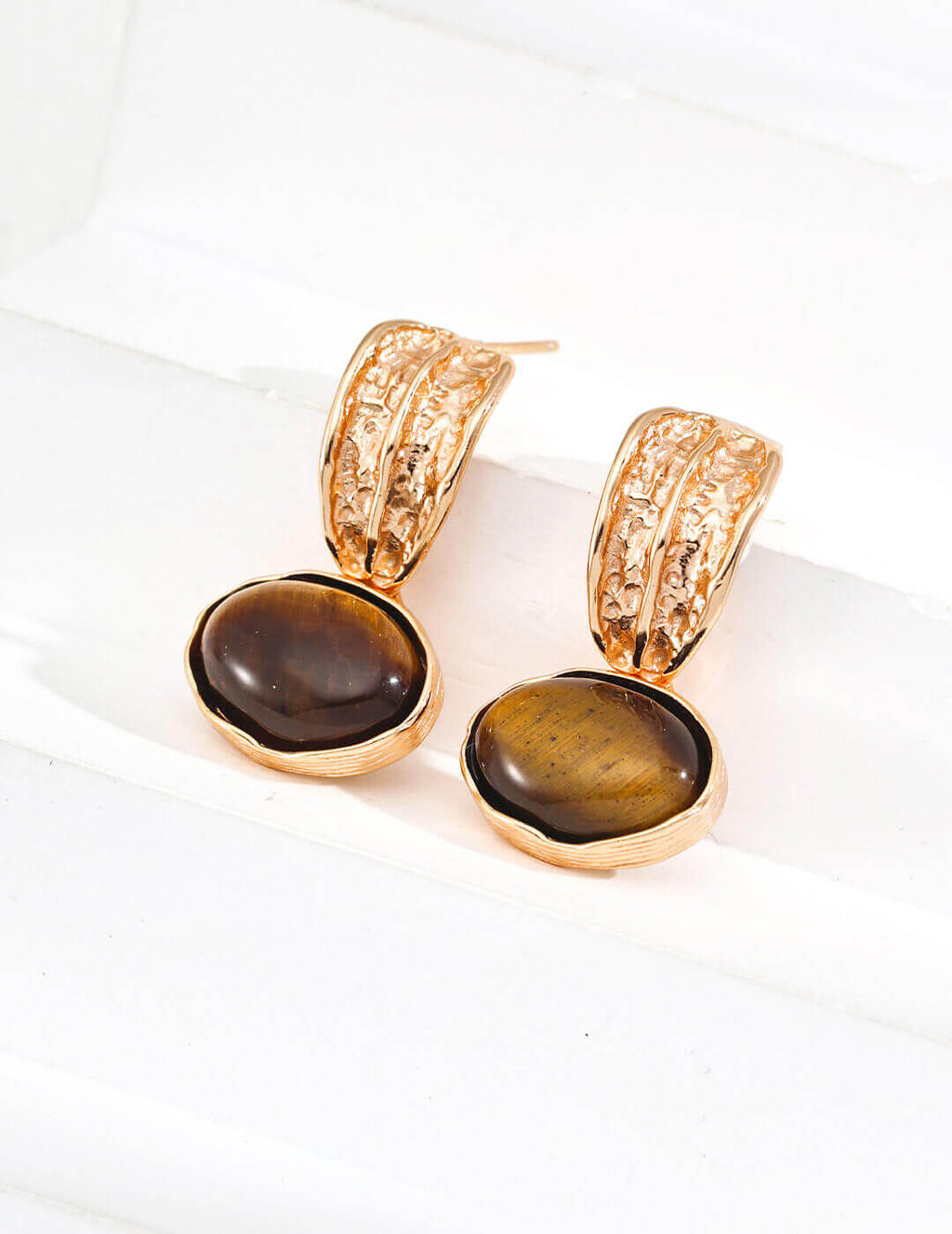 Side view of Tiger's Eye earrings on model, showcasing warm golden brown gemstones with chatoyancy.

