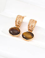 Side view of Tiger's Eye earrings on model, showcasing warm golden brown gemstones with chatoyancy.

