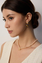 Warm Tiger's Eye earrings creating cozy, sophisticated atmosphere in intimate social settings.