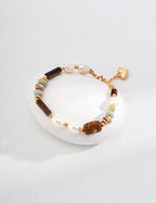 Beaded bracelet with gold accents on a white dish