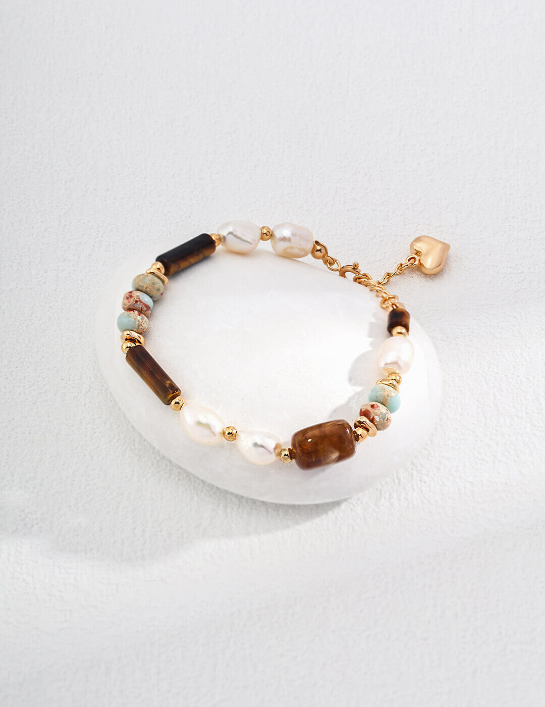 Beaded bracelet with gold accents on a white dish