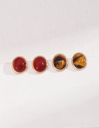 Front view of tiger's eye and onyx stud earrings in vintage gold S925 silver.