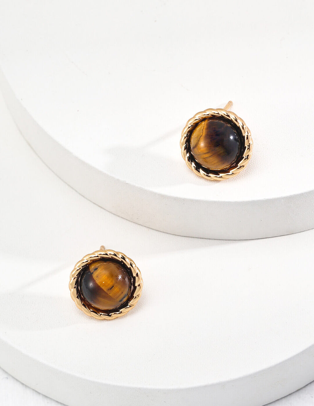 Pair of Tiger's Eye stud earrings displayed together on neutral background.