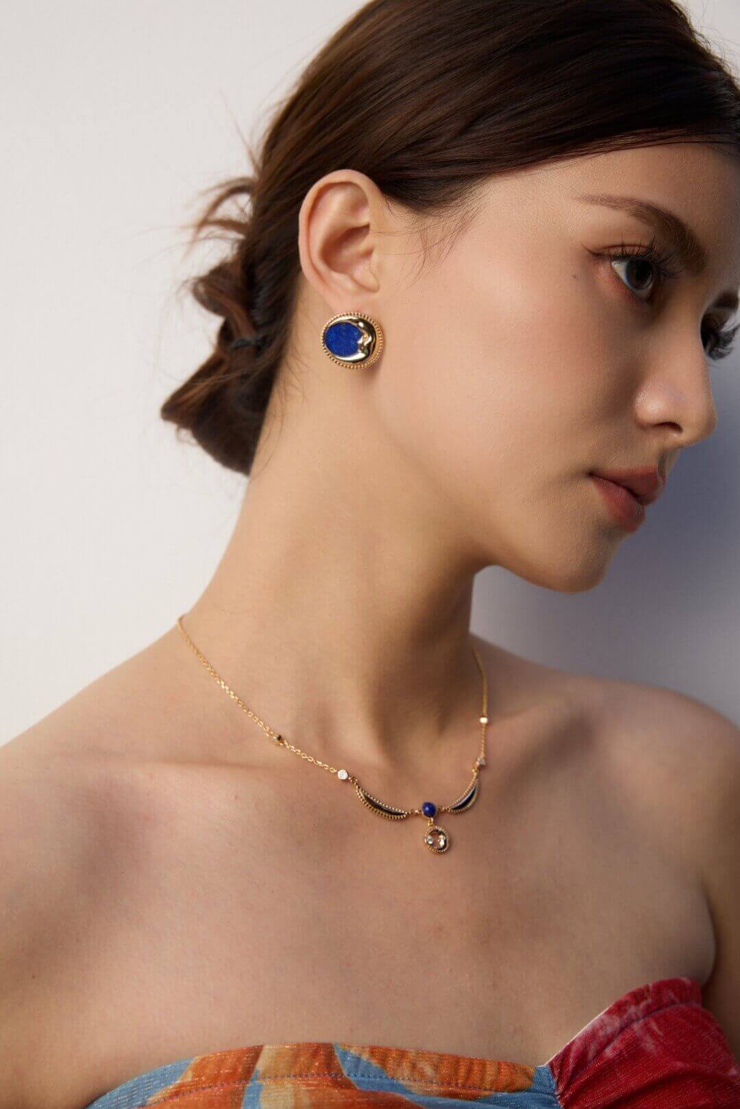 Model portrait showcasing timeless luxury of vintage Lapis Lazuli earrings, perfect for those who appreciate celestial elegance.