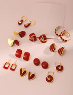 Close-up of vibrant red enamel finish on K gold plated earrings, showcasing smooth and bold color.