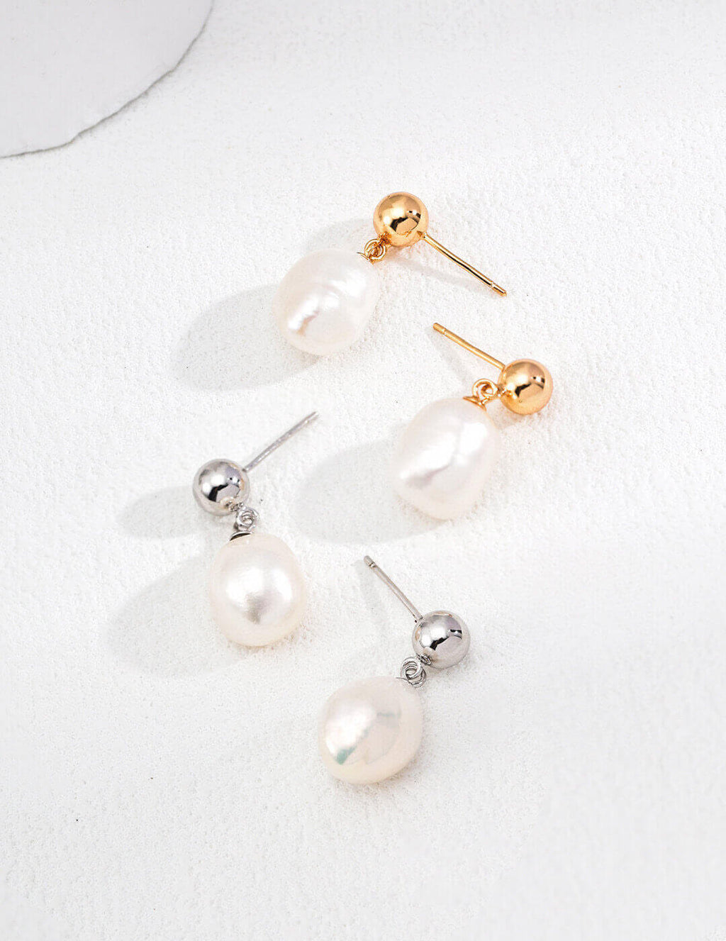 Vintage baroque natural pearl earrings in 925 sterling silver with a gold tone accent, showcasing their unique shape and elegance.
