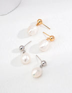 Vintage baroque natural pearl earrings in 925 sterling silver with a gold tone accent, showcasing their unique shape and elegance.