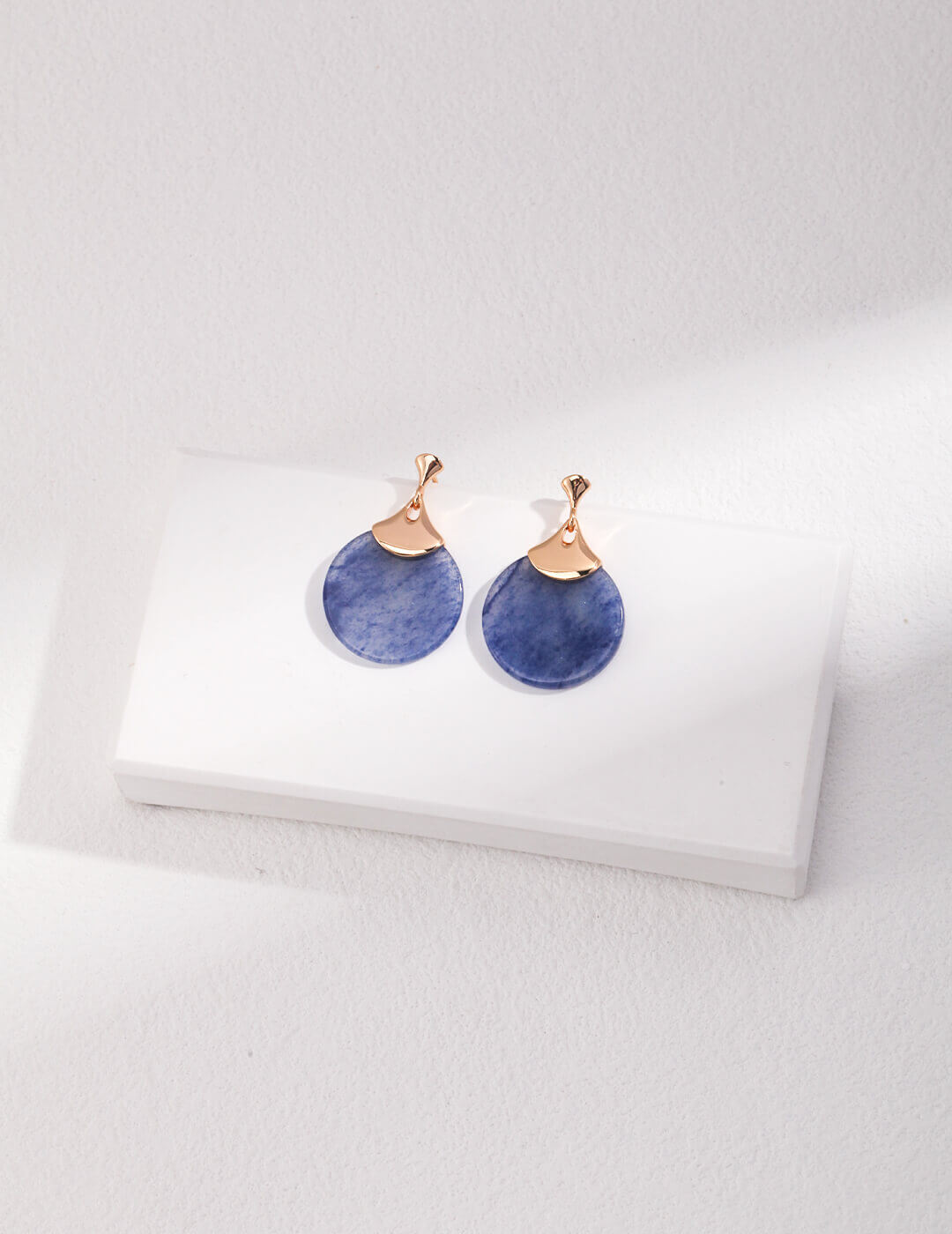 Front view of vintage gold fan drop earrings with blue Aventurine stone.