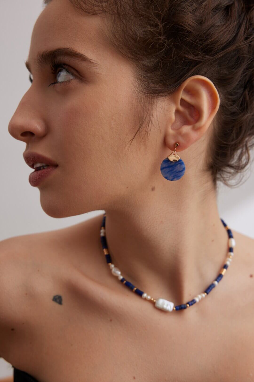 Blue Aventurine earrings adding a bohemian touch to a casual outfit.