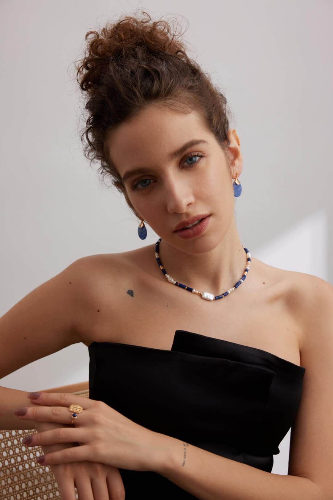 Vintage fan earrings paired with an elegant dress for a special occasion.