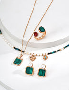 Vintage color malachite necklace in natural sunlight, showcasing green stone's beauty and pristine setting.