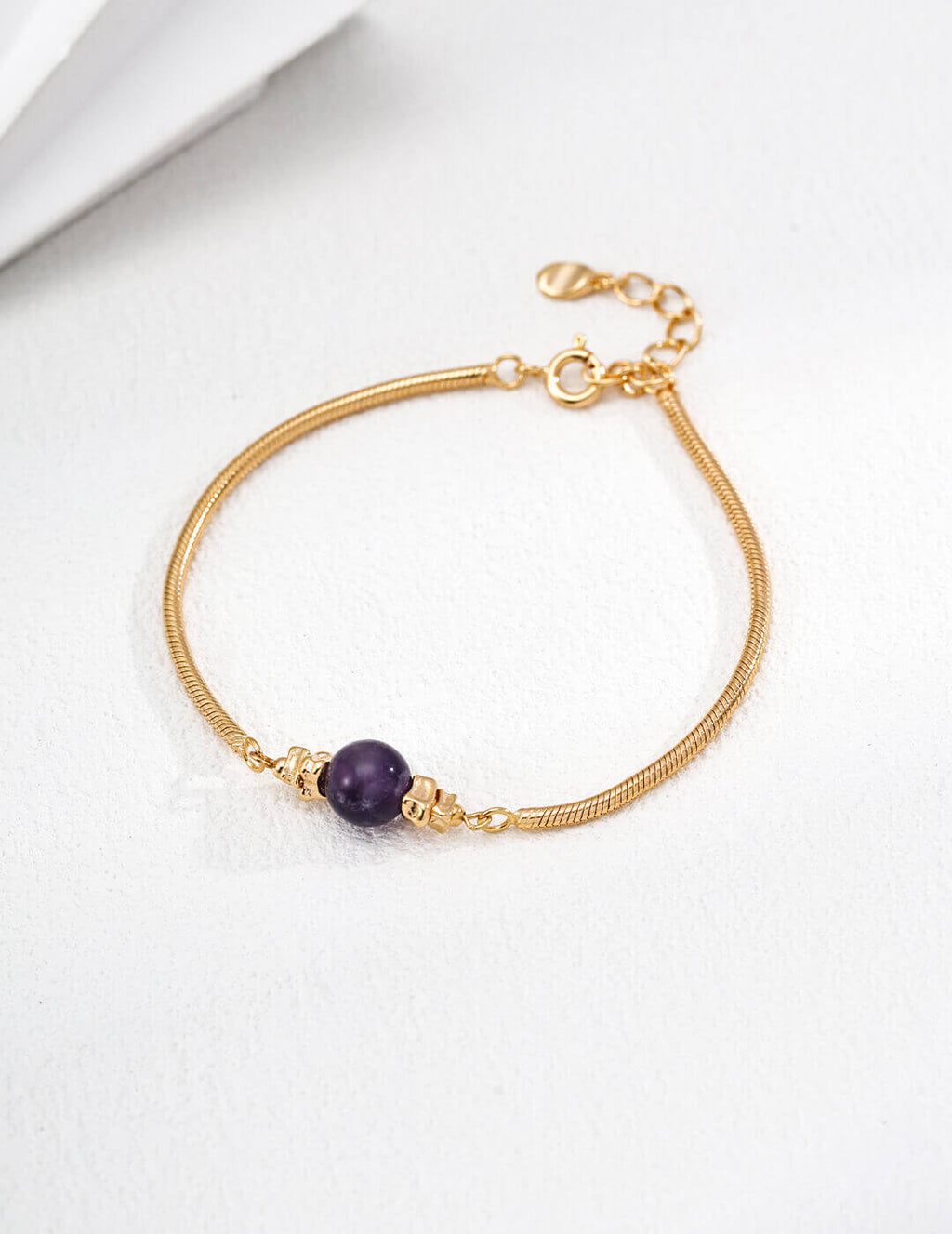 Front view of the vintage gold amethyst bead bracelet on a wrist.