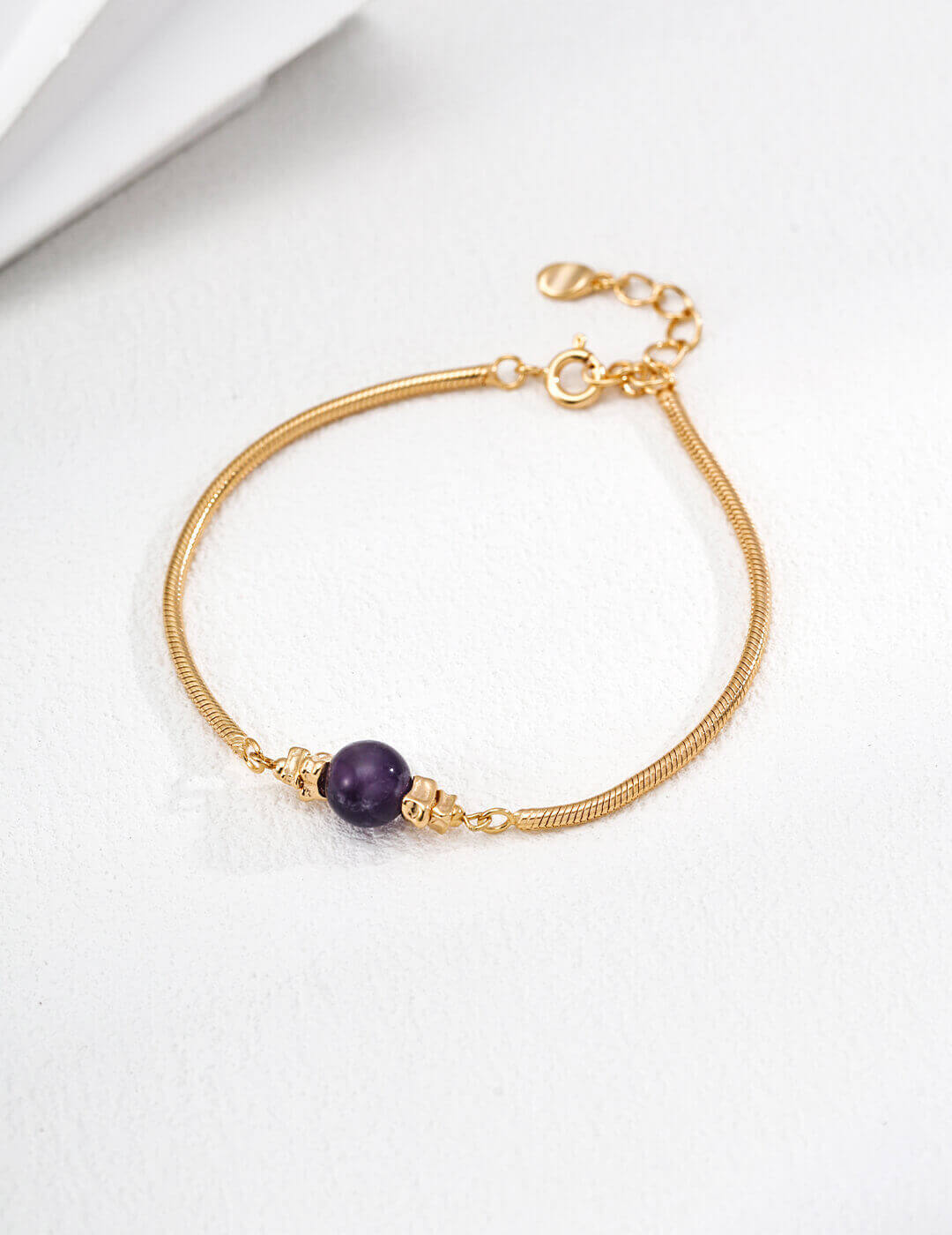 Front view of the vintage gold amethyst bead bracelet on a wrist.