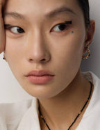 Vintage gold pearl and onyx stud earrings beautifully complementing various skin tones.