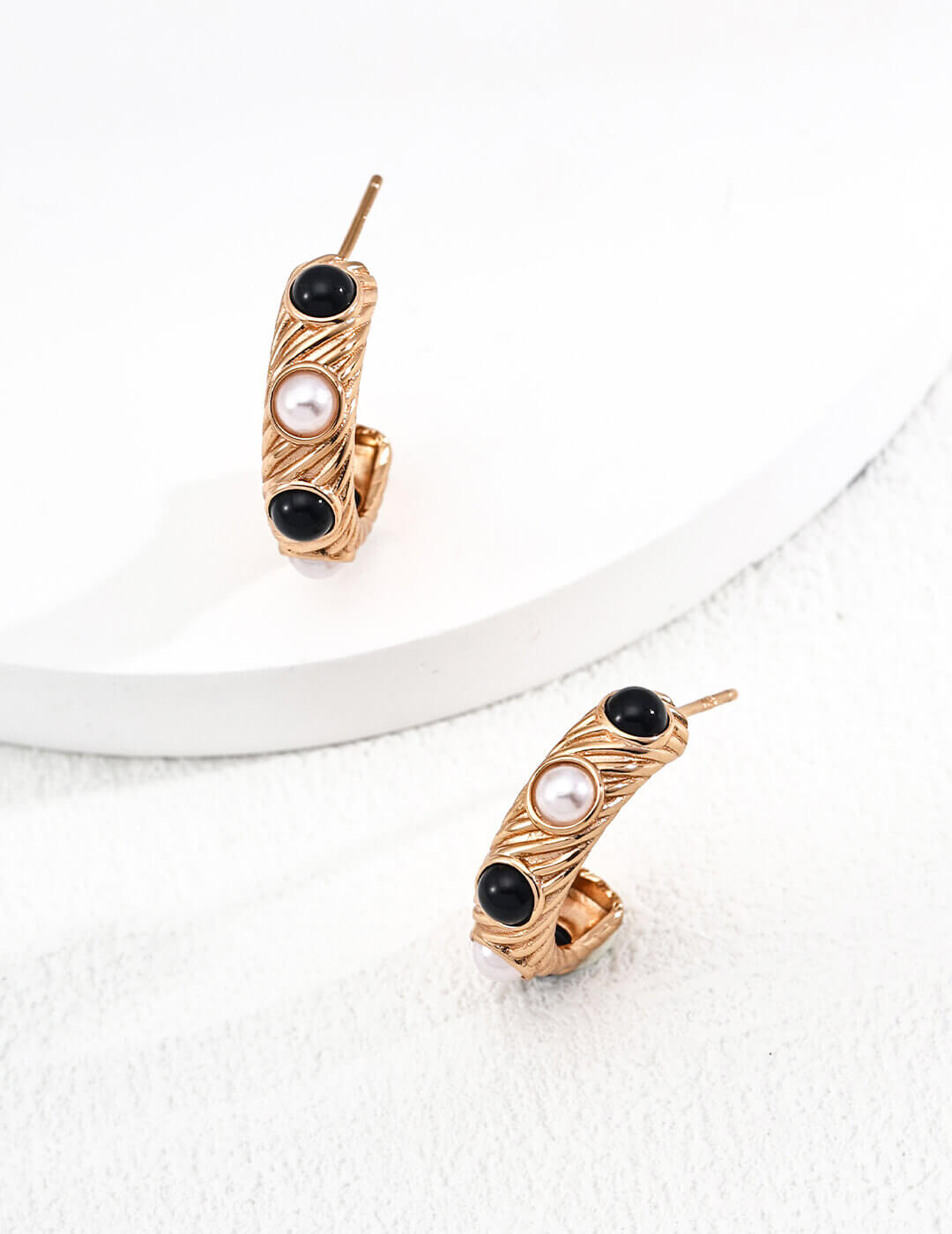Vintage gold finish natural pearl and black onyx stud earrings, adding refined sophistication to your look.