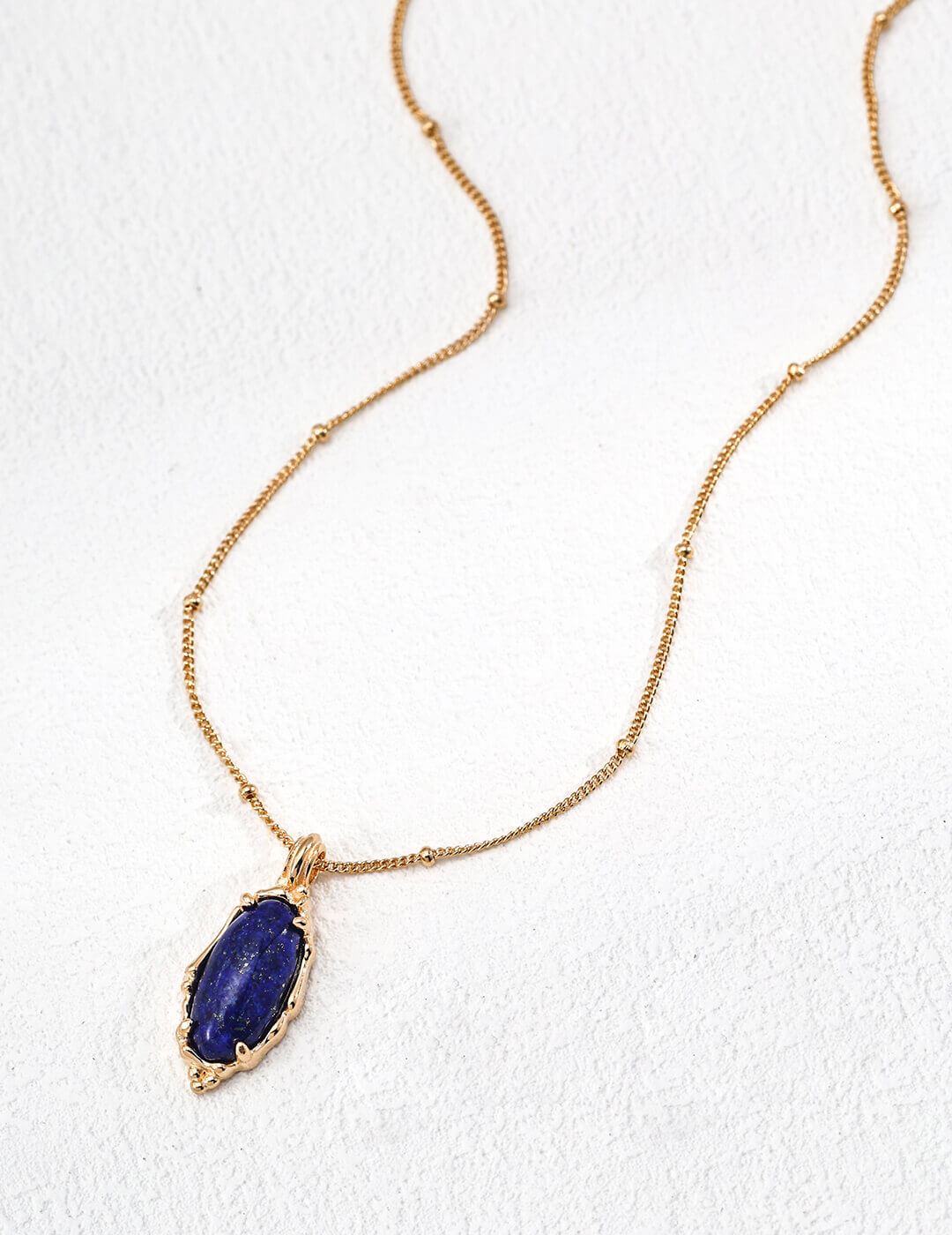 Front view of vintage Lapis Lazuli pendant necklace on model.