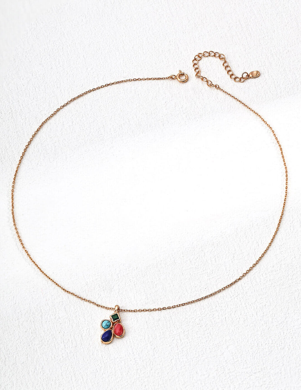 Macro detail highlighting the textures and colors of lapis lazuli, turquoise, and rhodochrosite.