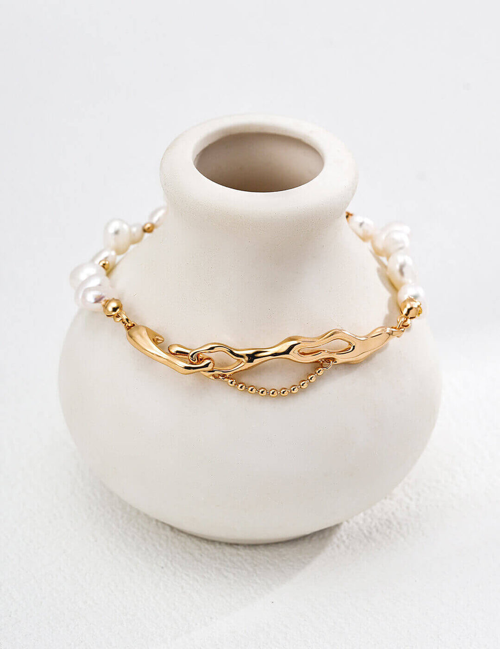 Close-up of vintage gold clasp and extender chain on pearl bracelet.