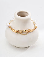 Close-up of vintage gold clasp and extender chain on pearl bracelet.
