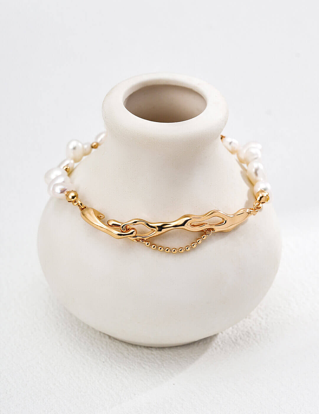 Close-up of vintage gold clasp and extender chain on pearl bracelet.