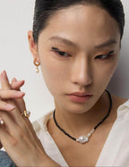 Vintage style pearl earrings with wood grain design, perfectly matching a retro-inspired fashion outfit.
