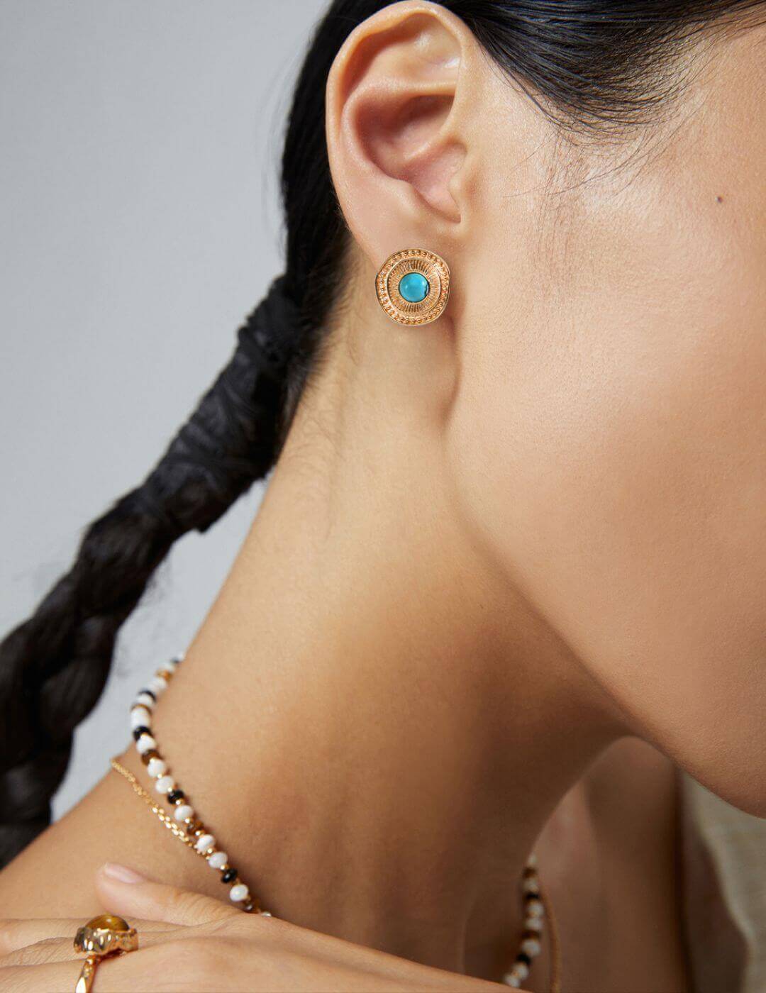 Female model wearing the vintage turquoise stud earrings, side view.