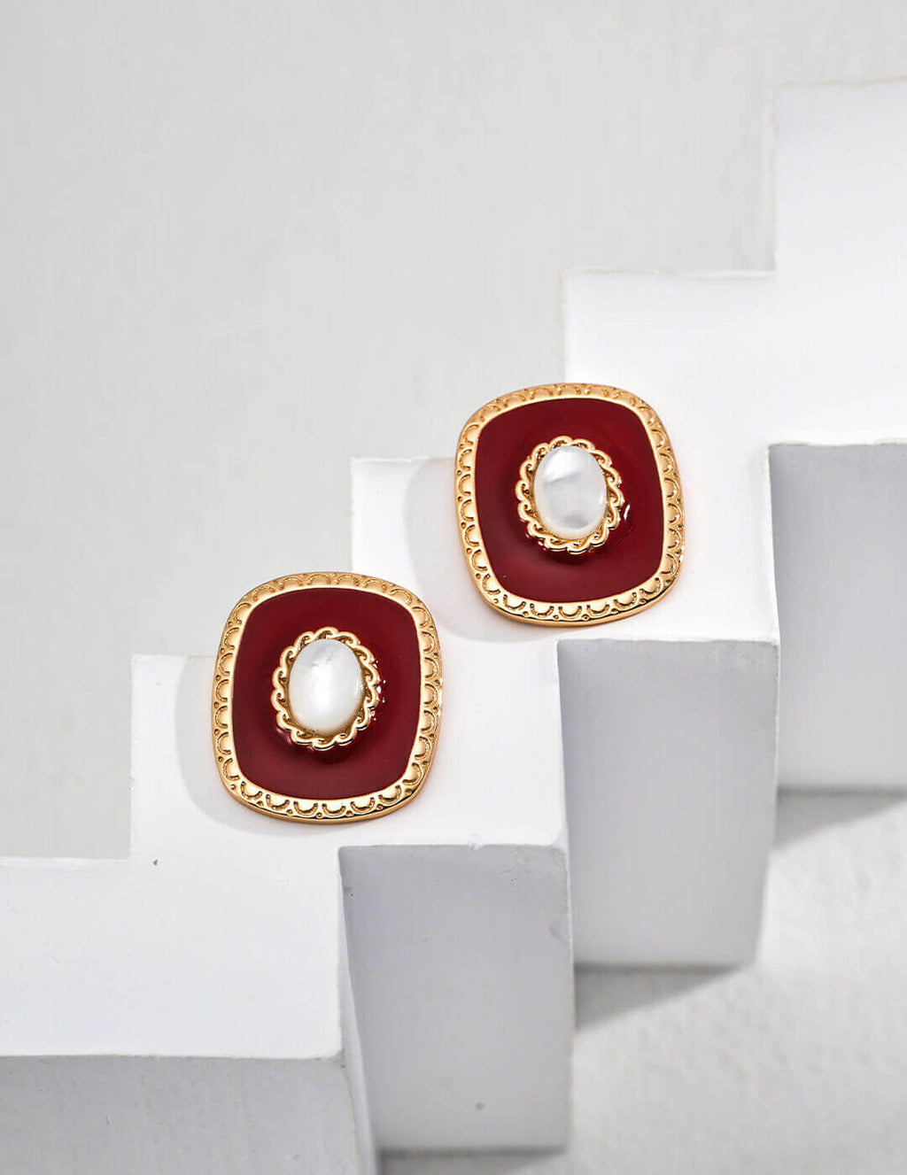 Minimalist white shell and red enamel drop earrings in 925 sterling silver on a white background.