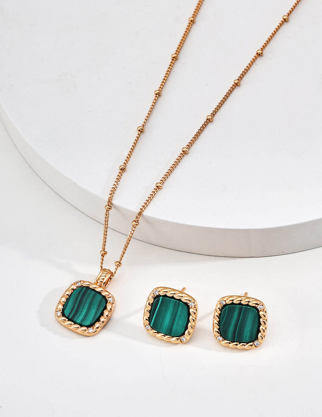 Front view of zircon and malachite stud earrings in vintage gold S925 silver.